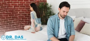 A distressed couple sits on a bed.