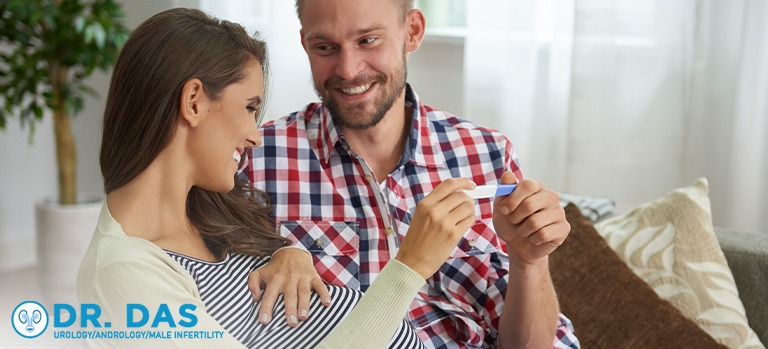 Happy couple holding a positive pregnancy test