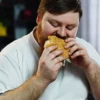 Guy eating burger